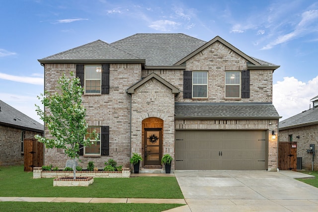 10125 Autumn Leaves Ln, Aubrey, TX 76227 - view of front of home featuring concrete driveway, an attached garage, brick siding, and a shingled roof