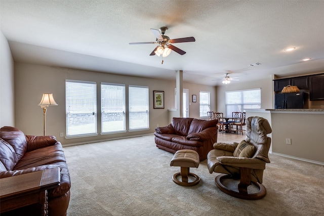 2044 Meadow Park Dr, Princeton, TX 75407 - living room featuring light colored carpet, ceiling fan, baseboards, and a textured ceiling
