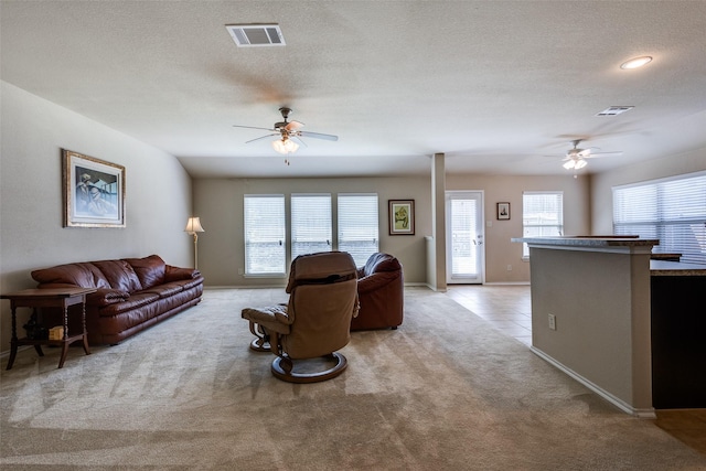 2044 Meadow Park Dr, Princeton, TX 75407 - living area with a ceiling fan, light colored carpet, a textured ceiling, and baseboards