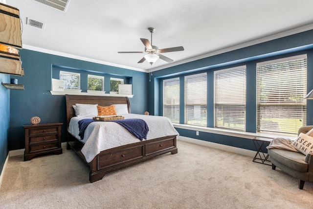 carpeted bedroom featuring ornamental molding, baseboards, and ceiling fan