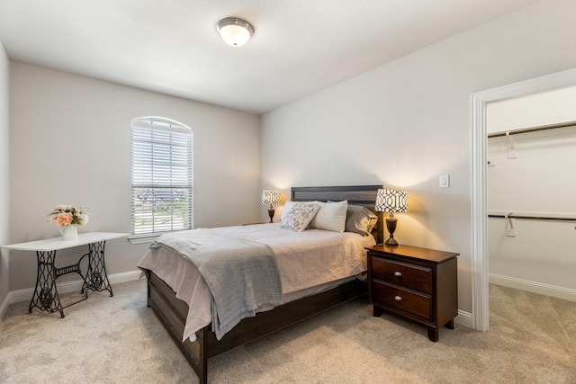 bedroom featuring carpet floors, baseboards, a spacious closet, and a closet