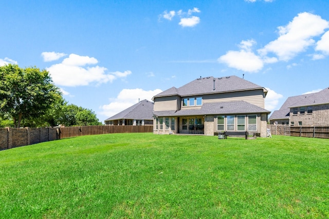 back of property with roof with shingles and brick siding