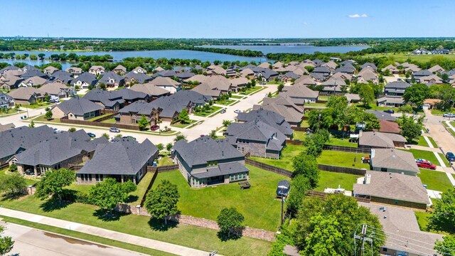 aerial perspective of suburban area with a nearby body of water