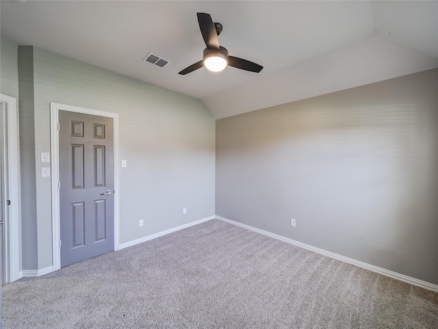 carpeted spare room featuring a ceiling fan, baseboards, and lofted ceiling