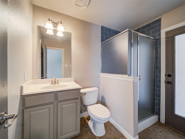 bathroom featuring tile patterned flooring, a shower stall, toilet, and a textured wall