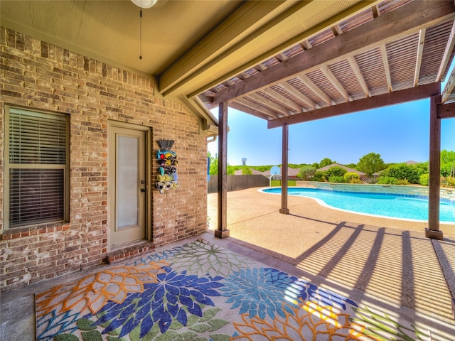 view of swimming pool with a patio area, ceiling fan, and fence