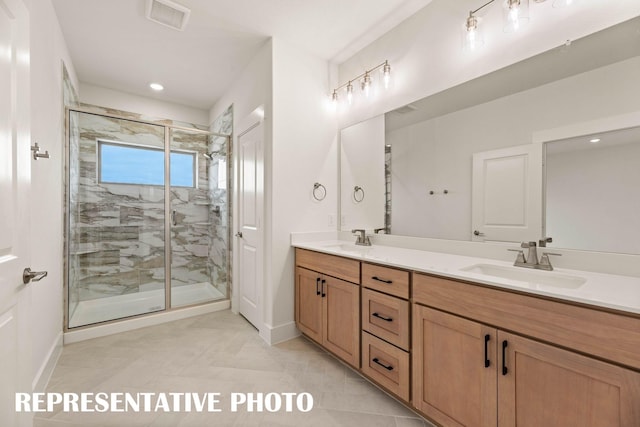 bathroom with baseboards, a stall shower, double vanity, recessed lighting, and tile patterned floors