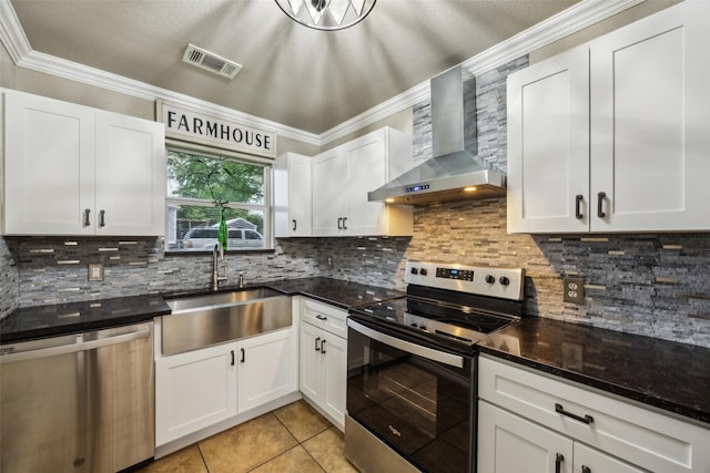 182 Willowcreek Ln, Rockwall, TX 75032 - kitchen featuring appliances with stainless steel finishes, wall chimney exhaust hood, crown molding, light tile patterned flooring, and a sink