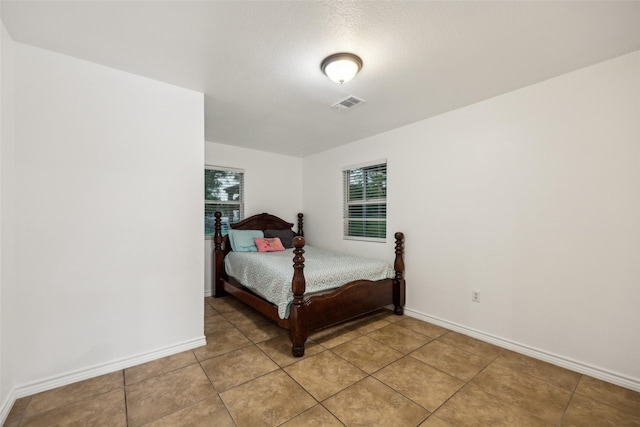 182 Willowcreek Ln, Rockwall, TX 75032 - bedroom featuring multiple windows, baseboards, and light tile patterned flooring