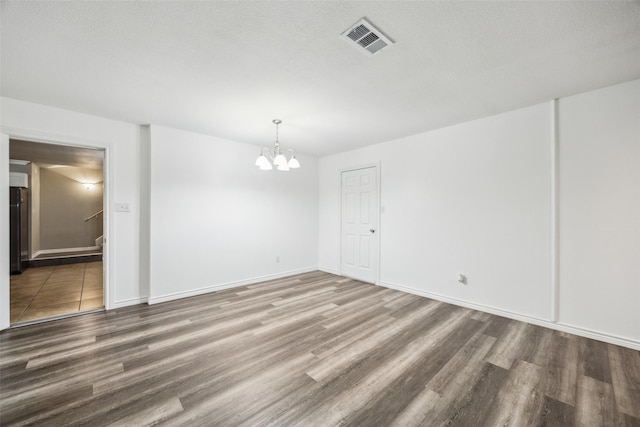182 Willowcreek Ln, Rockwall, TX 75032 - unfurnished room featuring a chandelier, wood finished floors, and baseboards