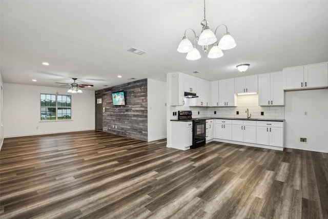 182 Willowcreek Ln, Rockwall, TX 75032 - kitchen with black range with electric cooktop, a sink, dark countertops, a ceiling fan, and a chandelier