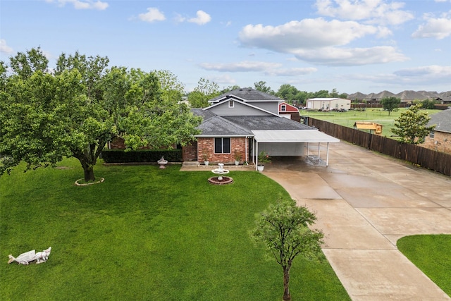 182 Willowcreek Ln, Rockwall, TX 75032 - view of front facade with driveway, brick siding, a shingled roof, and an attached carport