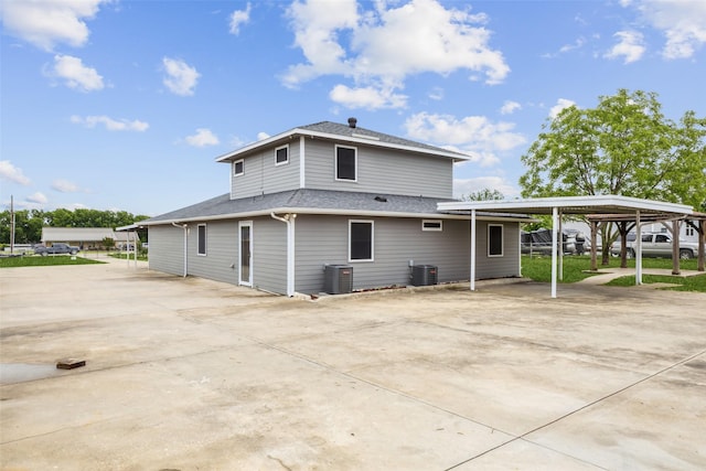 182 Willowcreek Ln, Rockwall, TX 75032 - back of property with a carport, driveway, central AC unit, and a shingled roof