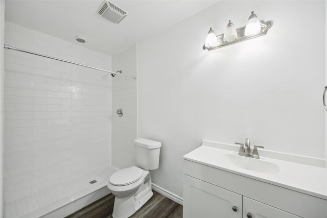 182 Willowcreek Ln, Rockwall, TX 75032 - bathroom with toilet, wood finished floors, tiled shower, vanity, and baseboards