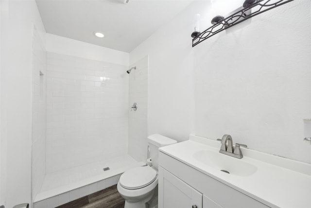 182 Willowcreek Ln, Rockwall, TX 75032 - full bathroom with toilet, a tile shower, wood finished floors, and vanity