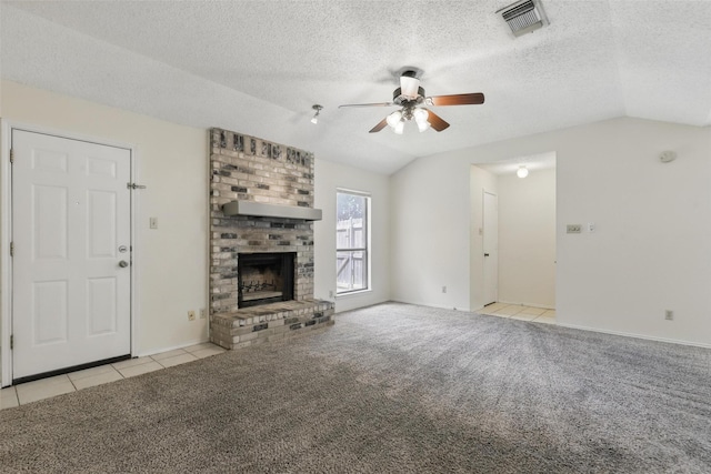 1021 Irene St, Burleson, TX 76028 - unfurnished living room featuring lofted ceiling, ceiling fan, carpet flooring, a brick fireplace, and tile patterned floors