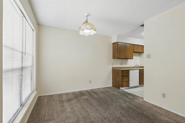 1021 Irene St, Burleson, TX 76028 - kitchen with white dishwasher, light colored carpet, healthy amount of natural light, a sink, and a textured ceiling