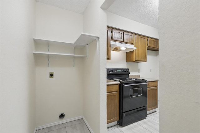 1021 Irene St, Burleson, TX 76028 - kitchen featuring black electric range oven, under cabinet range hood, light countertops, a textured ceiling, and brown cabinetry