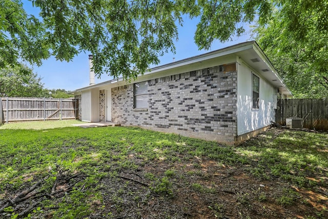 1021 Irene St, Burleson, TX 76028 - view of side of property with a chimney and central AC