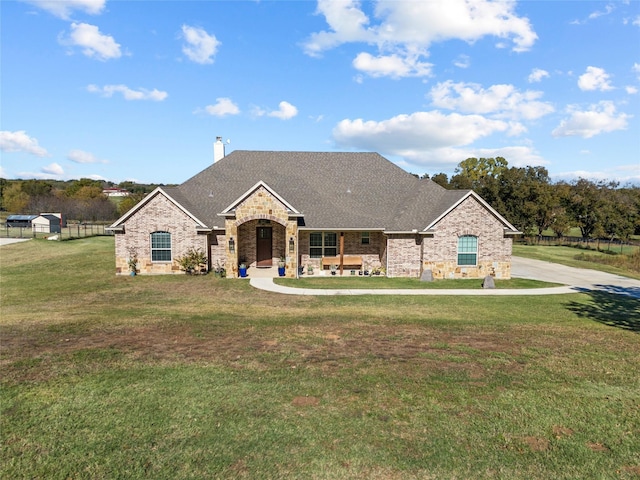 3611 Bella Ct, Weatherford, TX 76088 - french country style house with stone siding, a shingled roof, a chimney, and a front lawn