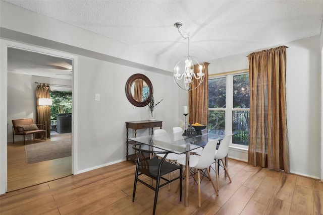 1738 Northaven Ct, Arlington, TX 76012 - dining area featuring light wood-type flooring, a chandelier, healthy amount of natural light, and a textured ceiling