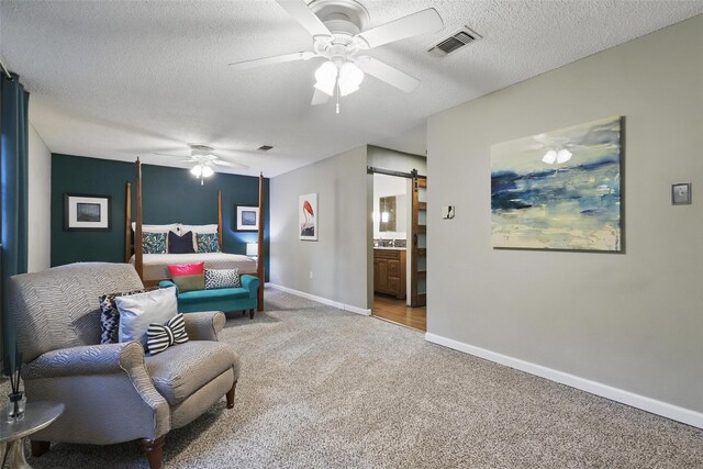 1738 Northaven Ct, Arlington, TX 76012 - sitting room with a barn door, carpet, a ceiling fan, baseboards, and a textured ceiling