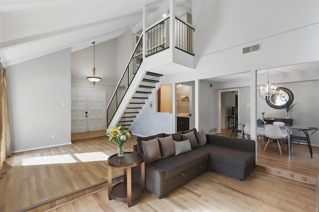 1738 Northaven Ct, Arlington, TX 76012 - living room featuring stairway, wood finished floors, high vaulted ceiling, a chandelier, and baseboards
