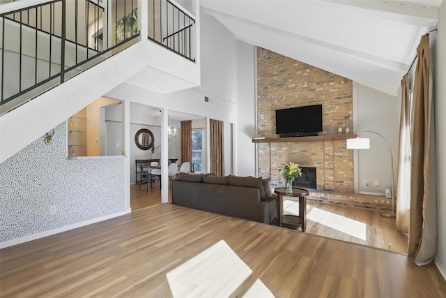 1738 Northaven Ct, Arlington, TX 76012 - living area with high vaulted ceiling, wood finished floors, stairway, a brick fireplace, and beamed ceiling