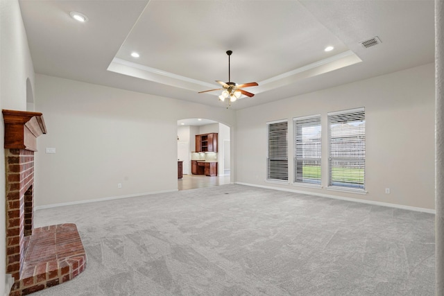 6328 Pinionpark Way, Fort Worth, TX 76179 - unfurnished living room featuring arched walkways, a raised ceiling, light carpet, and recessed lighting