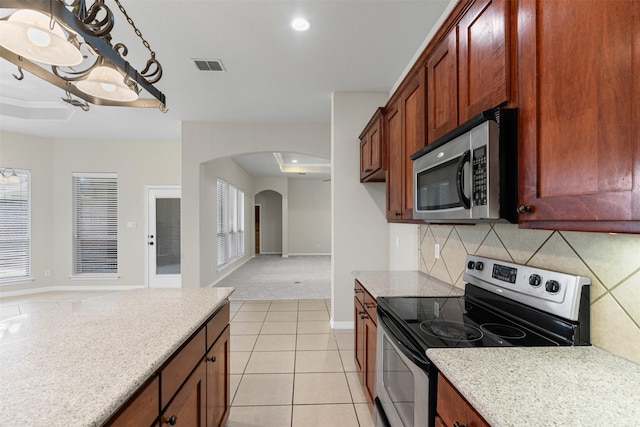 6328 Pinionpark Way, Fort Worth, TX 76179 - kitchen with stainless steel appliances, arched walkways, tasteful backsplash, baseboards, and open floor plan
