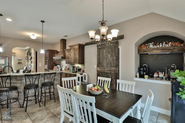 3726 Enchanted Rock Rd, Abilene, TX 79606 - dining room featuring arched walkways, light tile patterned floors, and a chandelier