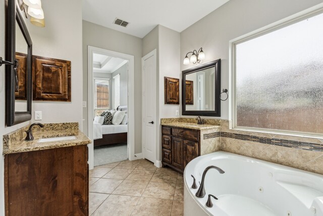 2831 Sheffield Ct, Trophy Club, TX 76262 - full bathroom featuring two vanities, a jetted tub, ensuite bathroom, and tile patterned flooring