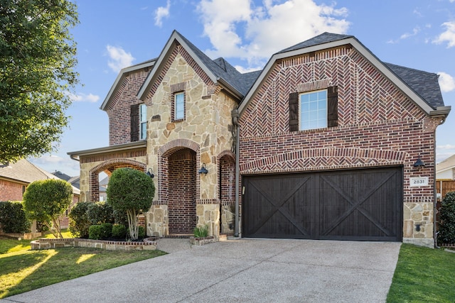 2831 Sheffield Ct, Trophy Club, TX 76262 - view of front facade featuring stone siding, brick siding, and driveway