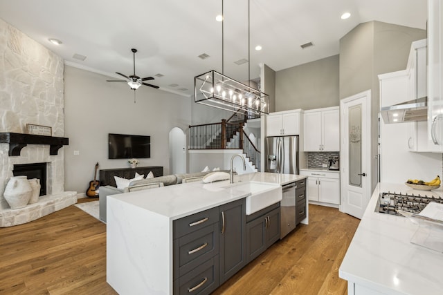 2831 Sheffield Ct, Trophy Club, TX 76262 - kitchen featuring a sink, appliances with stainless steel finishes, white cabinets, ceiling fan, and a towering ceiling