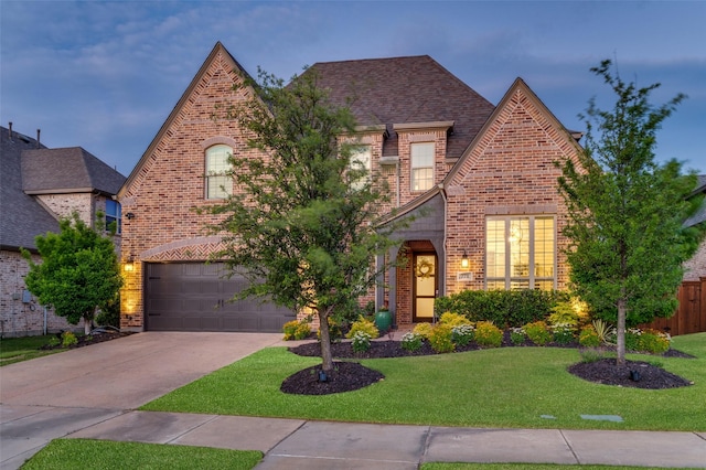 771 Drummond Dr, Prosper, TX 75078 - tudor house with brick siding, driveway, an attached garage, and roof with shingles