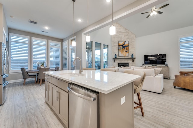771 Drummond Dr, Prosper, TX 75078 - kitchen featuring dishwasher, a stone fireplace, plenty of natural light, and a sink