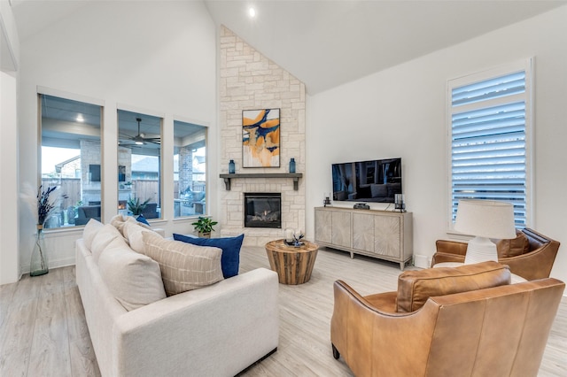 771 Drummond Dr, Prosper, TX 75078 - living room with light wood-style flooring, a fireplace, high vaulted ceiling, and a ceiling fan