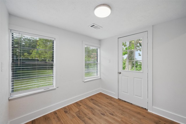 entrance foyer featuring wood finished floors and baseboards