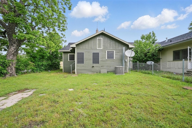 back of property with cooling unit and board and batten siding