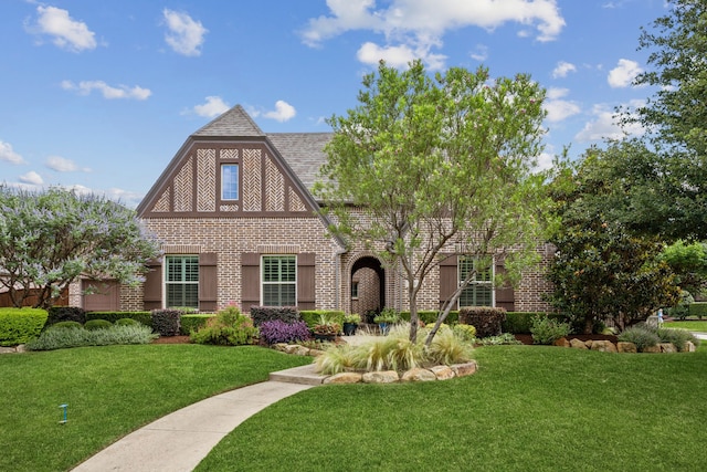 870 Swan Landing Ln, Allen, TX 75013 - tudor-style house with a front lawn and brick siding