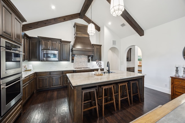 870 Swan Landing Ln, Allen, TX 75013 - kitchen featuring appliances with stainless steel finishes, a sink, beamed ceiling, tasteful backsplash, and dark wood finished floors