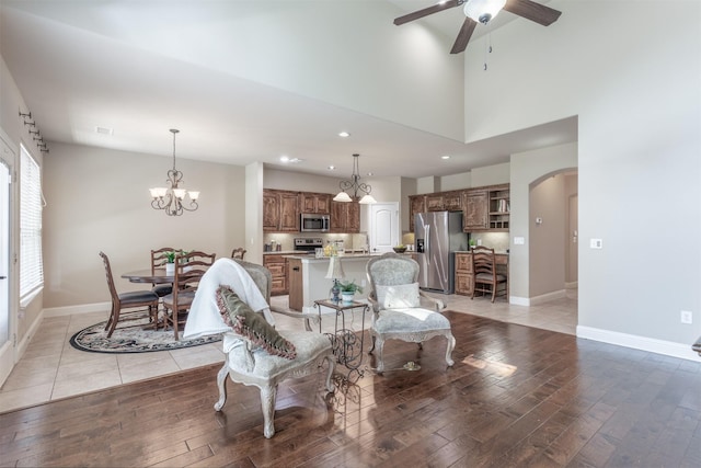 348 Terra Verde Ln, Mckinney, TX 75069 - living area with arched walkways, light wood finished floors, a ceiling fan, recessed lighting, and a chandelier