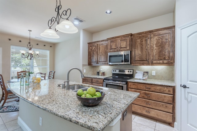 348 Terra Verde Ln, Mckinney, TX 75069 - kitchen with appliances with stainless steel finishes, a sink, light stone countertops, a chandelier, and light tile patterned floors