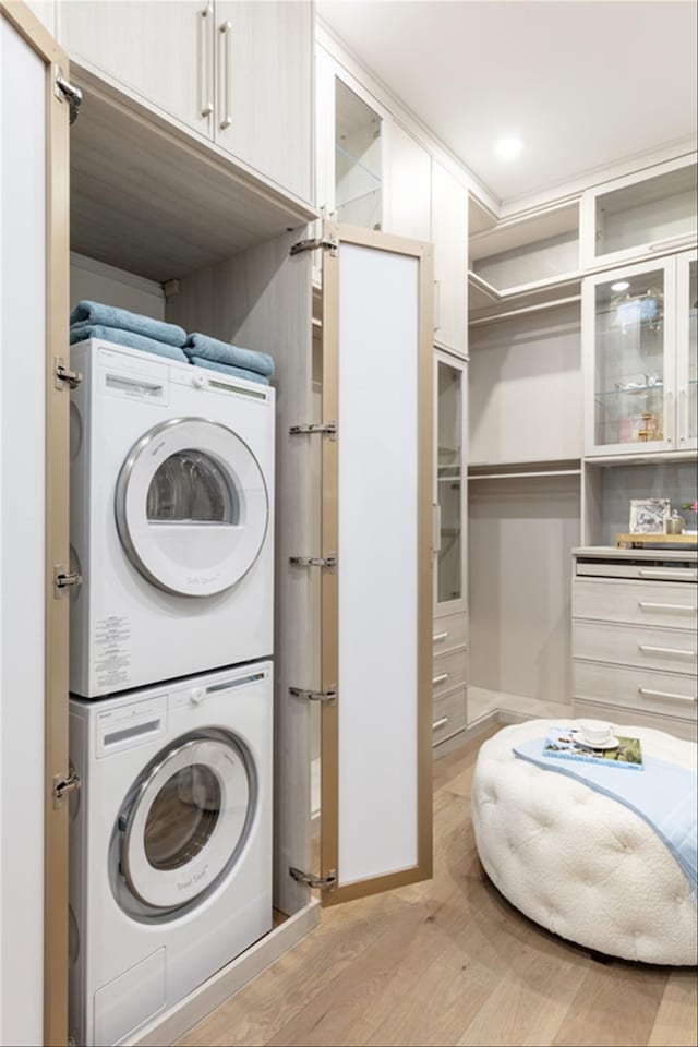 2300 Sorrelwood Ct, Celina, TX 75009 - laundry room with stacked washer / dryer, light wood-type flooring, and baseboards