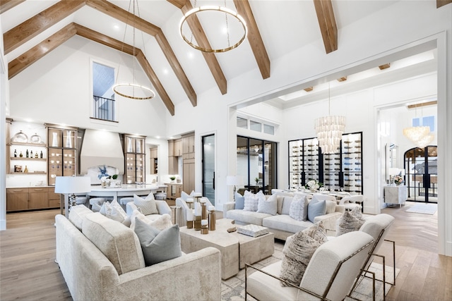 2300 Sorrelwood Ct, Celina, TX 75009 - living area featuring high vaulted ceiling, a chandelier, beamed ceiling, and light wood-style flooring