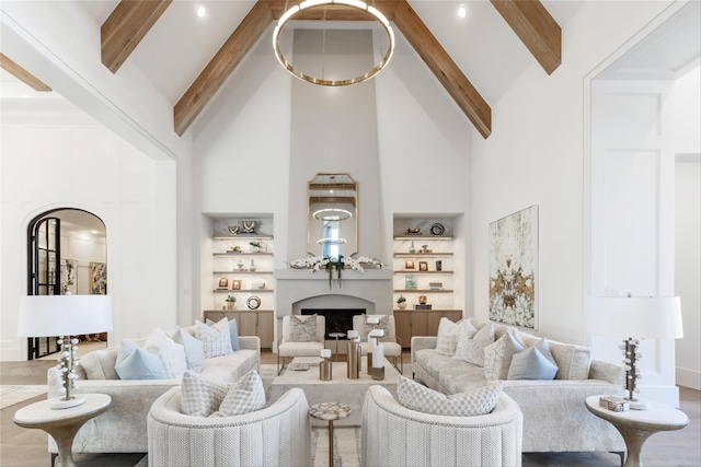 2300 Sorrelwood Ct, Celina, TX 75009 - living room featuring high vaulted ceiling, arched walkways, beamed ceiling, a premium fireplace, and built in features