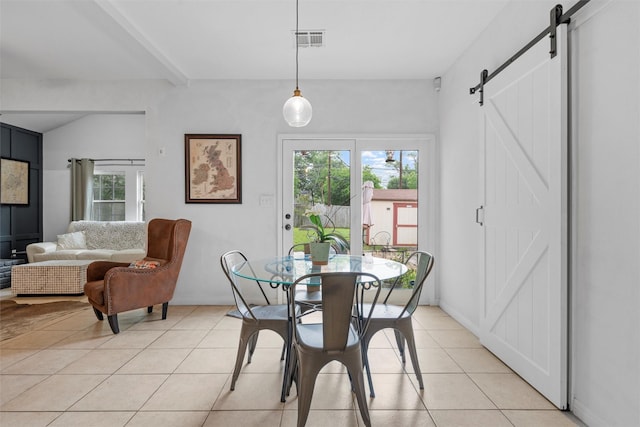 2923 Live Oak Ave, Waco, TX 76708 - dining space with a barn door and light tile patterned floors
