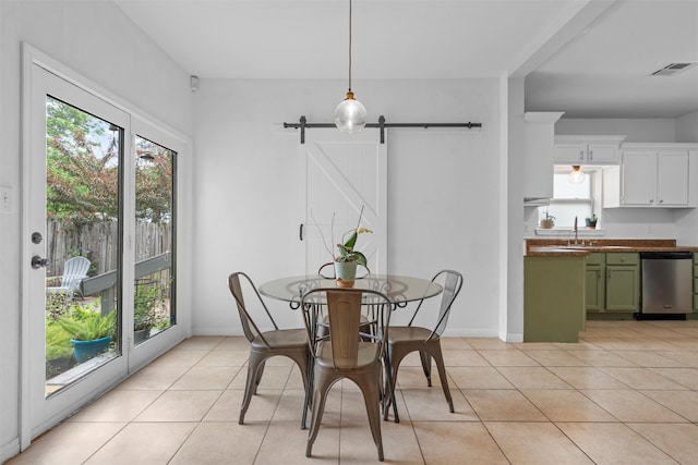 2923 Live Oak Ave, Waco, TX 76708 - dining space featuring light tile patterned flooring and a barn door