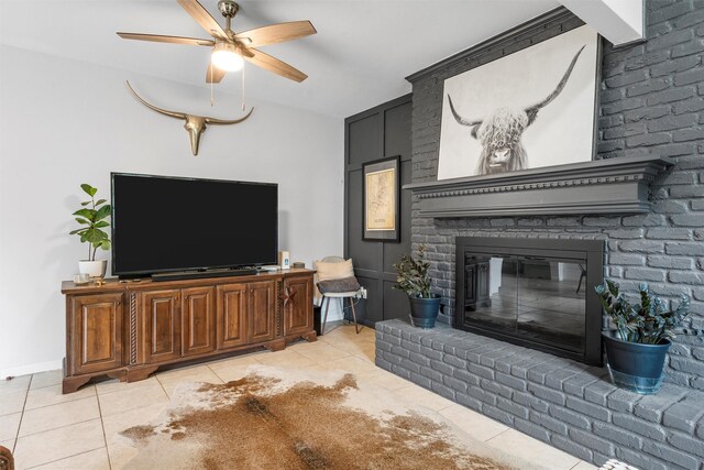 2923 Live Oak Ave, Waco, TX 76708 - living room with light tile patterned floors, a fireplace, a ceiling fan, and baseboards