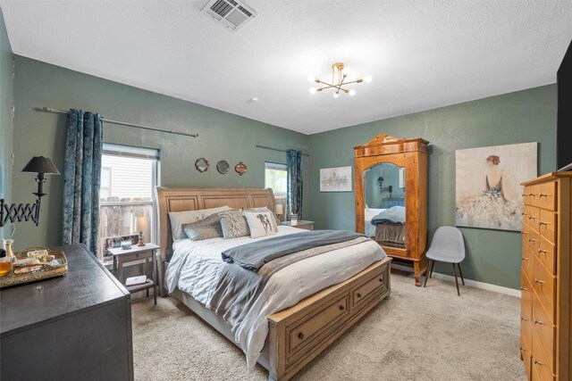 2923 Live Oak Ave, Waco, TX 76708 - bedroom featuring light colored carpet, multiple windows, and a chandelier